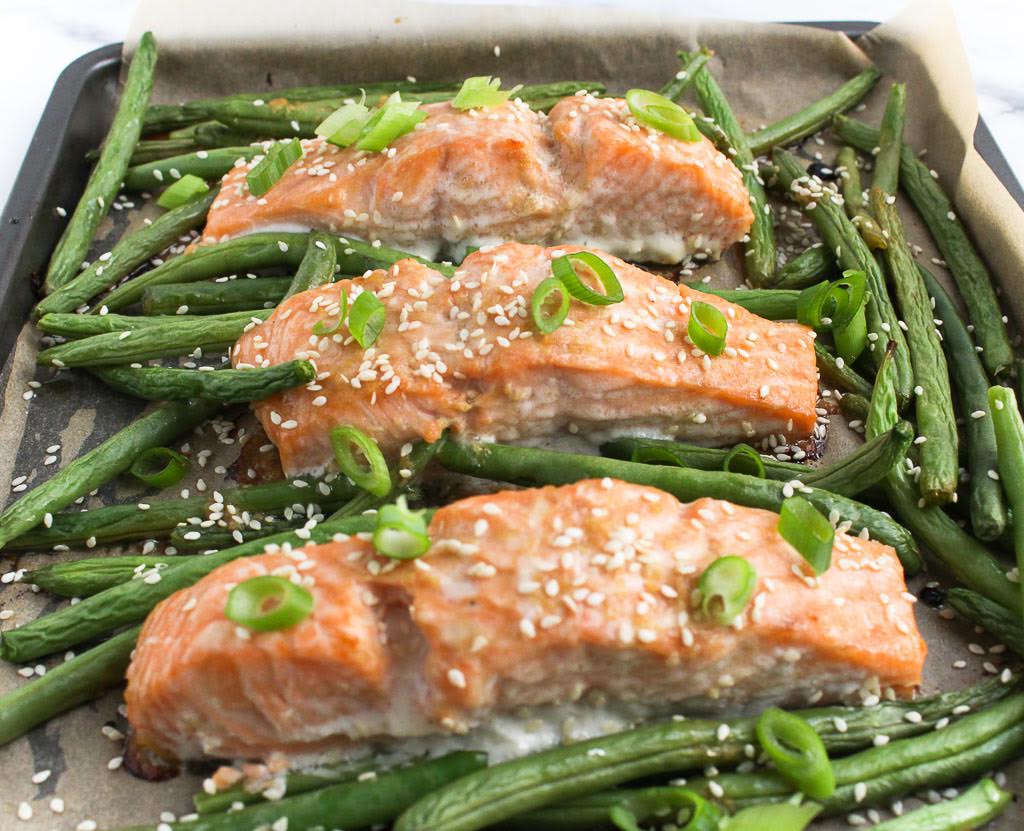 salmon with sesame seeds on a baking sheet
