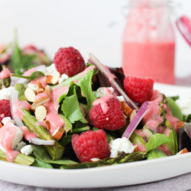 Spring Salad with Raspberry Vinaigrette on a white plate