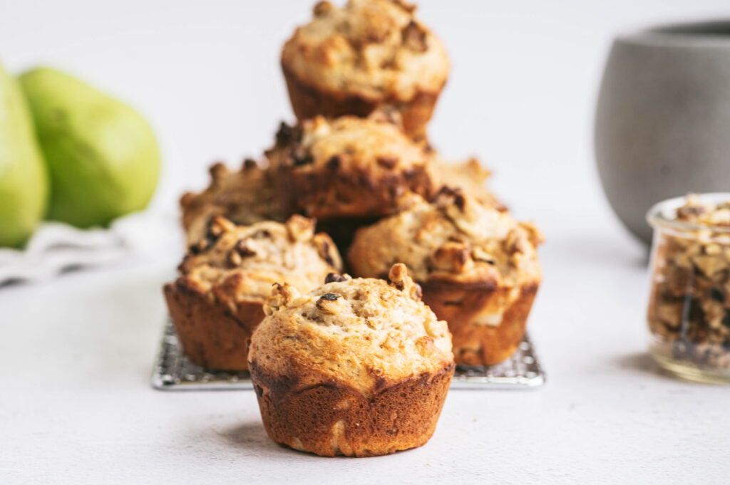 Pear walnut muffins stacked on top of each other
